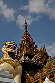 Yangon Myanmar. Shwedagon Pagoda (the Golden Stupa). The southern entrance guarded by two colossal chinthe (half lion, half-dragon guardian figures). 